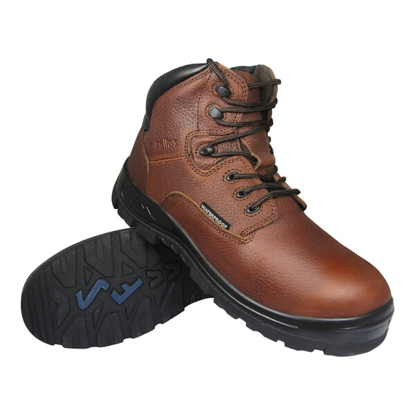 A pair of brown leather lace-up boots with black soles, one boot standing upright and the other showing the tread pattern on the sole.