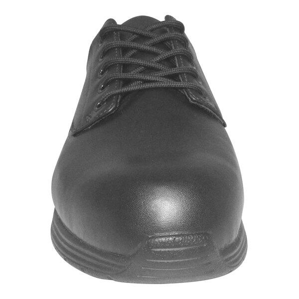 A close up of a black Genuine Grip leather shoe with laces and rubber soles.