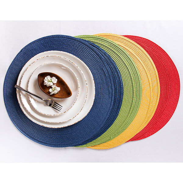 A navy blue RITZ polypropylene placemat with a plate and fork on it.