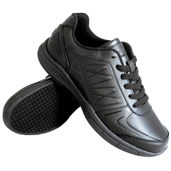 A pair of black athletic shoes with a textured sole and black laces, shown against a white background.