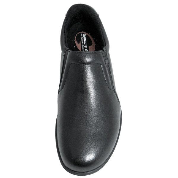 A close-up of a Genuine Grip black slip-on shoe with a rubber sole.