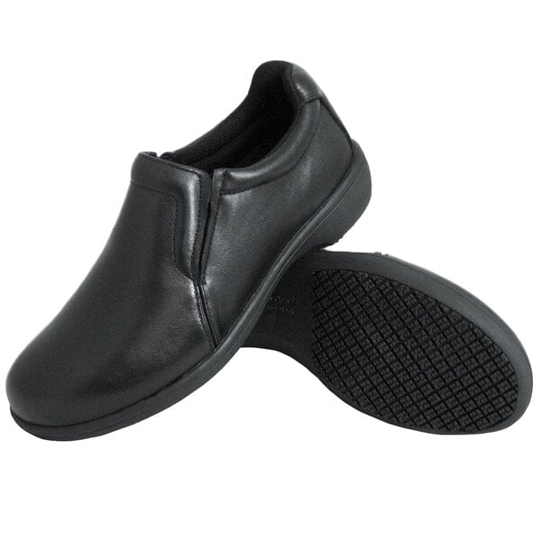 A pair of Genuine Grip black slip-on shoes with a black sole.