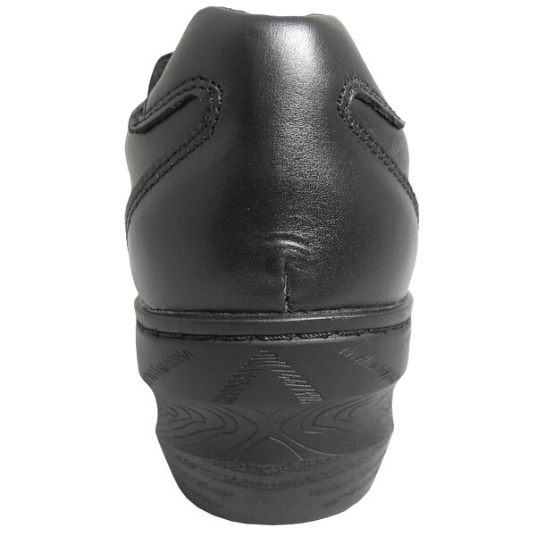 The bottom of a Genuine Grip black leather shoe.