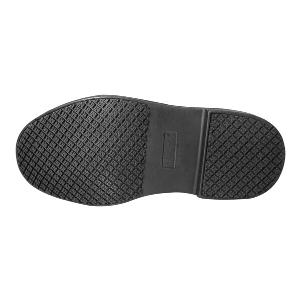 The black rubber sole of a Genuine Grip steel toe boot.