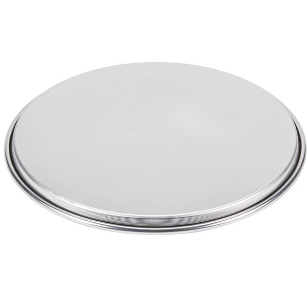 An American Metalcraft aluminum pizza pan with a wide silver rim.