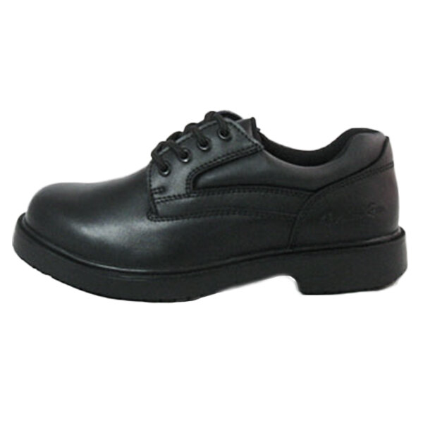 A close up of a Genuine Grip black leather Oxford shoe with laces and a rubber sole.