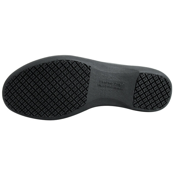 The black sole of a Genuine Grip black leather slip-on shoe.