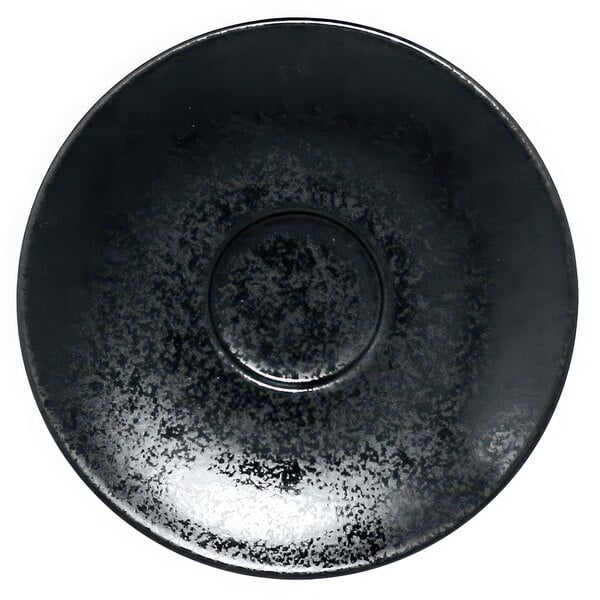 A black porcelain saucer with a black circle in the middle.