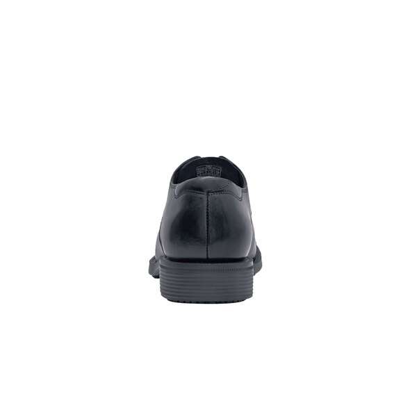 The back of a black Shoes For Crews Senator dress shoe.