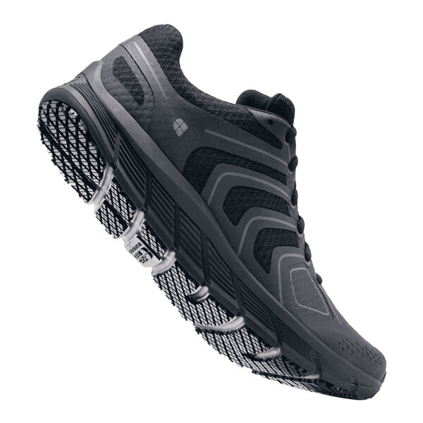 A black Shoes For Crews athletic shoe with a white background.