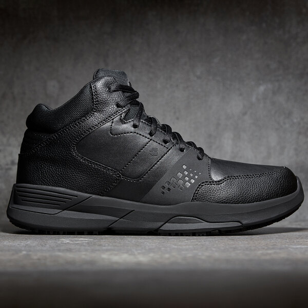 A black Shoes For Crews athletic shoe with a black sole.