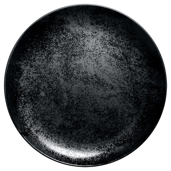 A white background with a black RAK Porcelain Karbon flat coupe plate with specks.