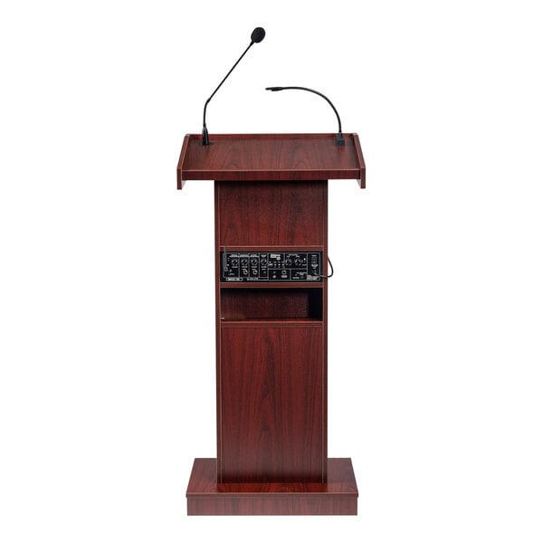 A wooden lectern with a mahogany finish, built-in sound system, and two attached microphones.