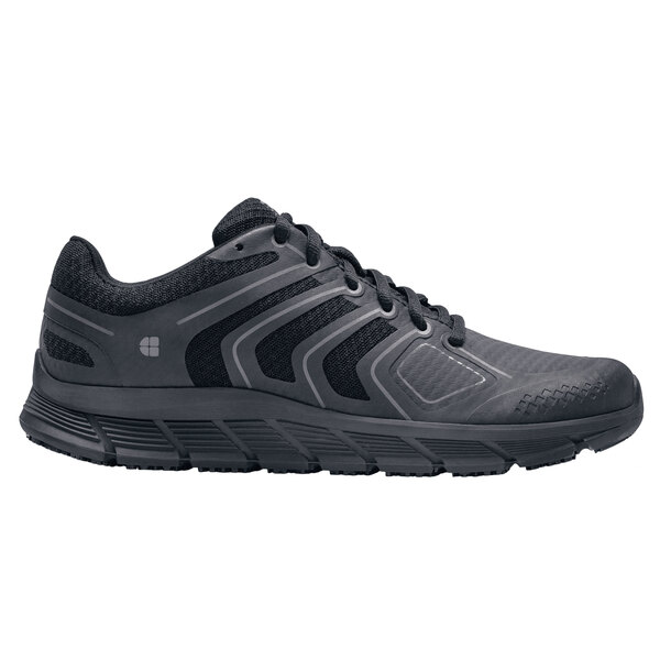 A black Shoes For Crews women's non-slip athletic shoe.