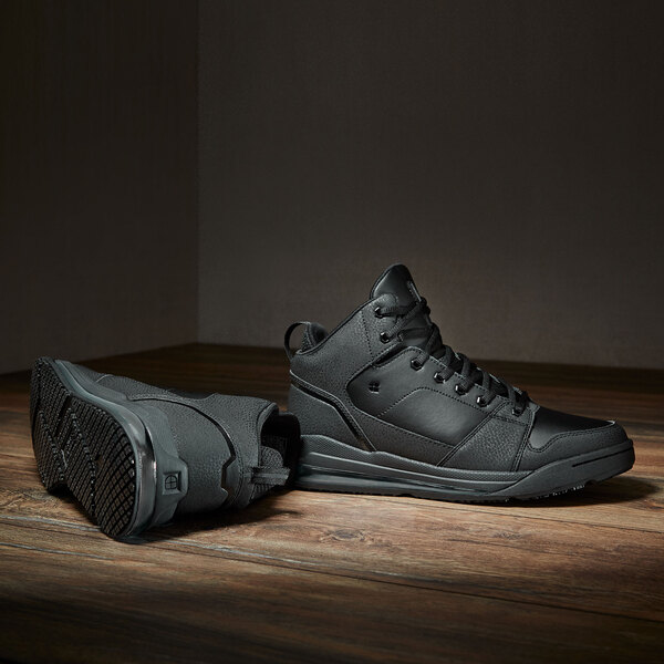 a pair of black shoes on a wooden floor