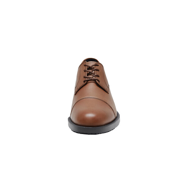 A brown Shoes For Crews Senator dress shoe with laces.