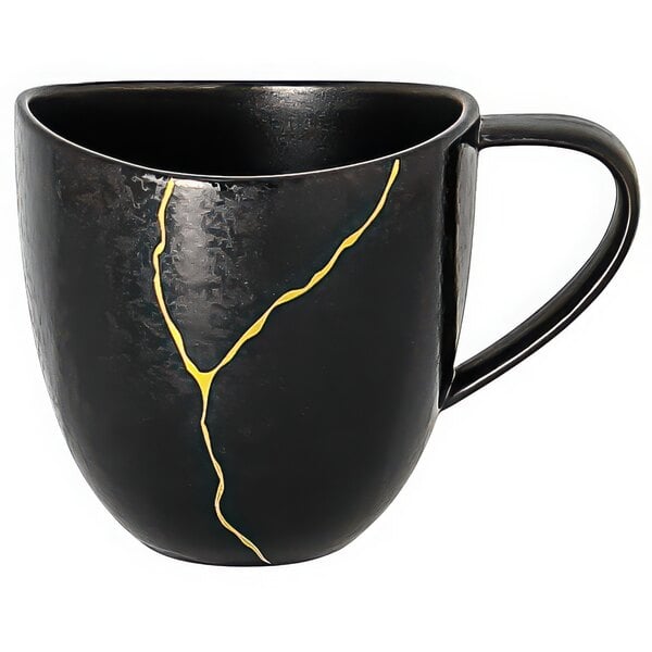 A black porcelain cup with gold lines on it.