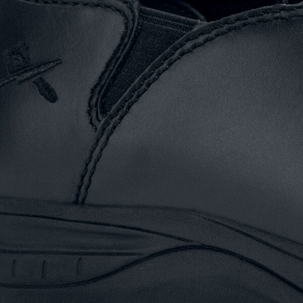 A black leather MOZO clog with a zipper on the side.