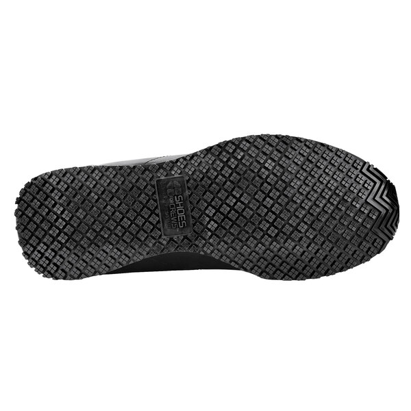 The textured sole of a black Shoes For Crews Avery women's athletic shoe.