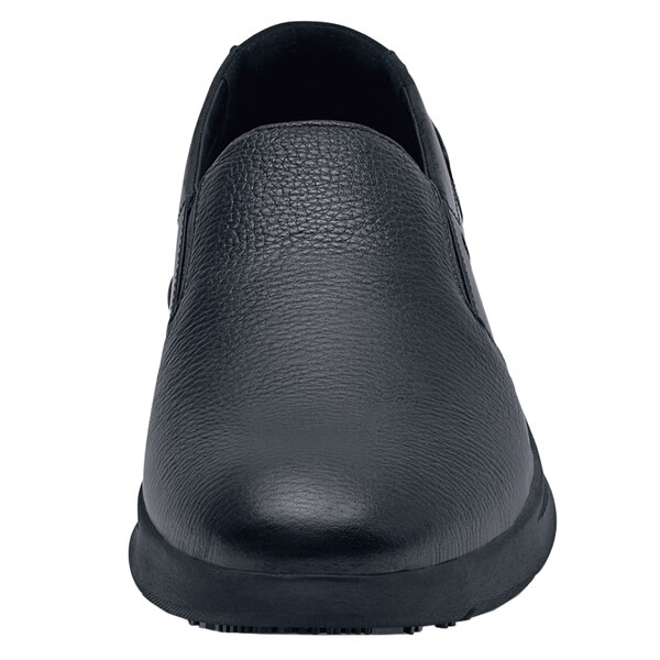 a black shoe with a white background