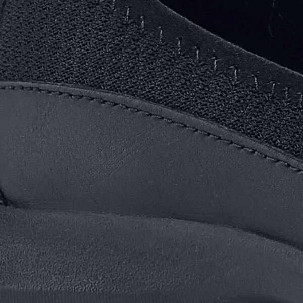 A close up of a black Shoes For Crews Yogi casual shoe.