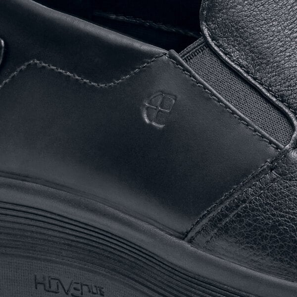 A close up of a black Shoes For Crews Arden slip-on shoe.