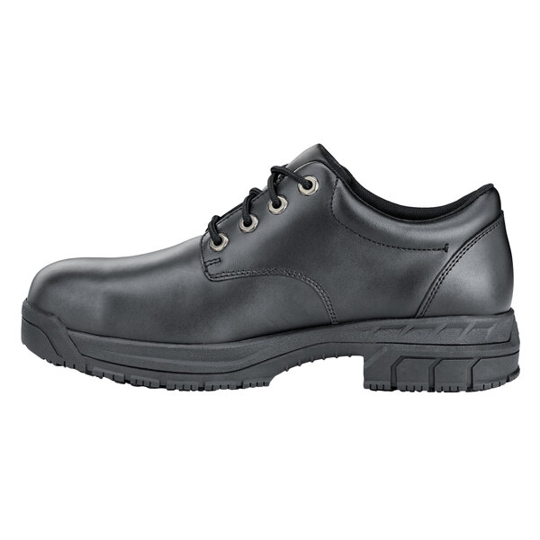 A black leather Shoes For Crews work boot for men with laces.