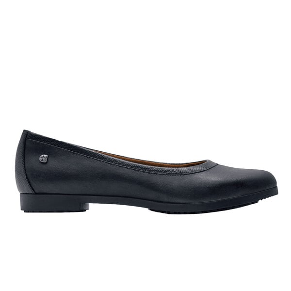 A black leather flat dress shoe for women.