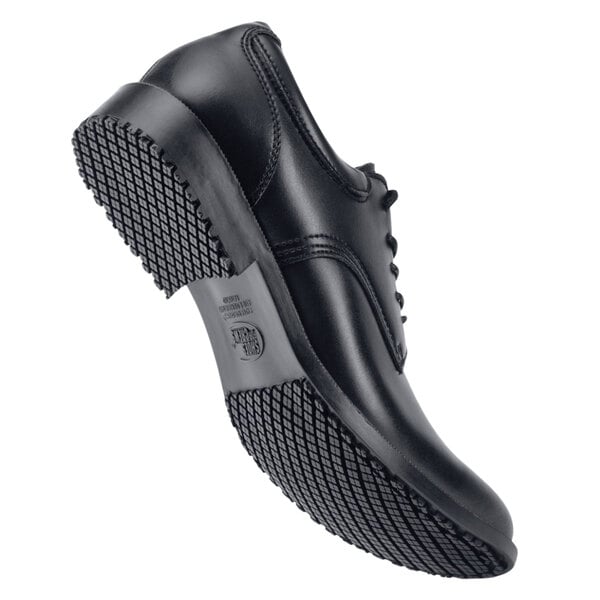 A black leather Shoes For Crews Cambridge men's dress shoe with rubber soles.