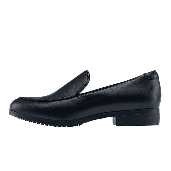 A black loafer with a rubber sole and pointed toe.