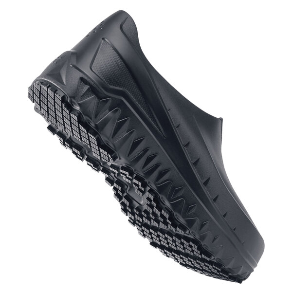 A black Shoes For Crews men's shoe with a rubber sole.