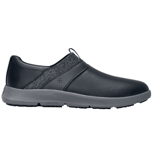 A black Shoes For Crews slip-on shoe with a grey sole.