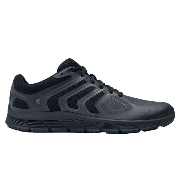 A close-up of a black Shoes For Crews Stride men's athletic shoe.