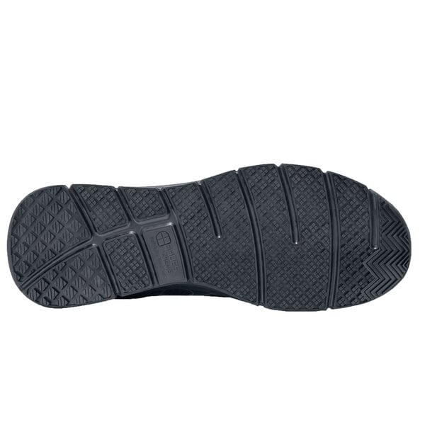 The black sole of a Shoes For Crews Stride men's athletic shoe.