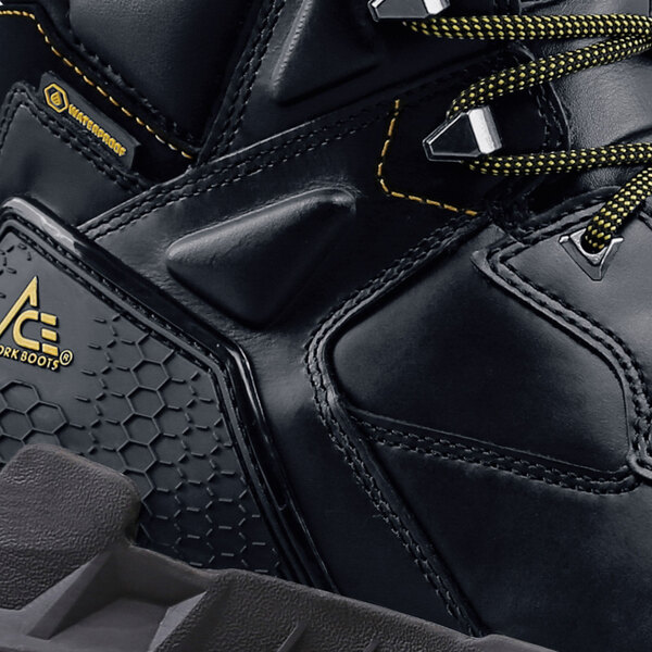 A close up of a black ACE Redrock safety boot with a yellow logo.