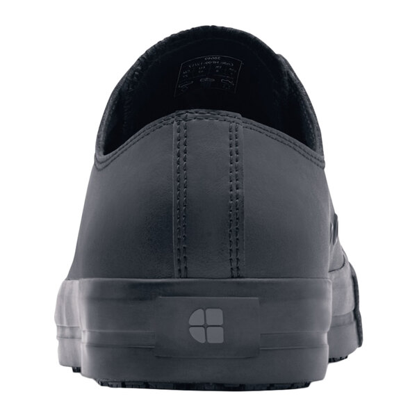 A black Shoes For Crews Delray men's leather casual shoe with a logo on it.