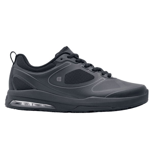 A black Shoes For Crews Revolution II athletic shoe with a white background.
