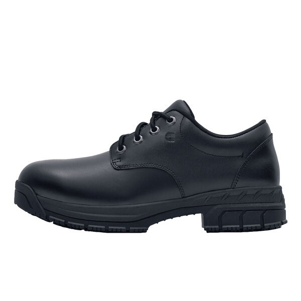 A black Shoes For Crews work boot for women with laces and a rubber sole.