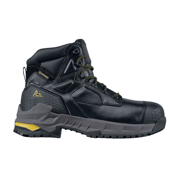 A close up of a black ACE Redrock work boot with yellow accents.