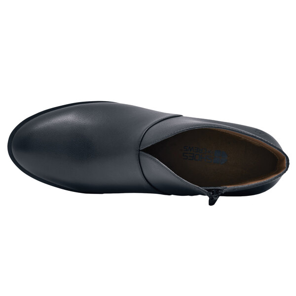 A black leather Shoes For Crews Delilah women's dress shoe with a blue sole.