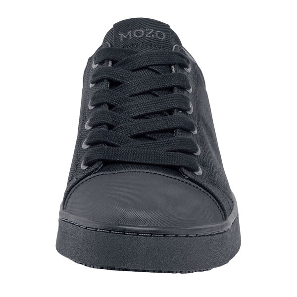 A close up of a black MOZO shoe with laces.