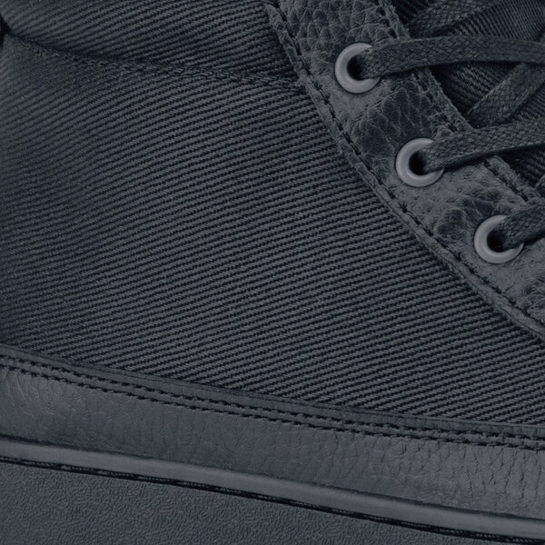 A black MOZO Padma shoe with a side zipper.