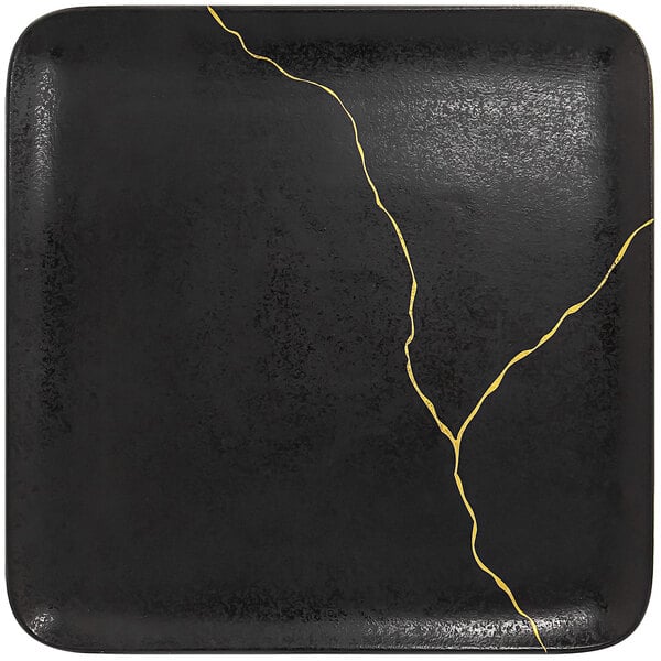 A RAK Porcelain black square porcelain plate with gold lines along the edge.