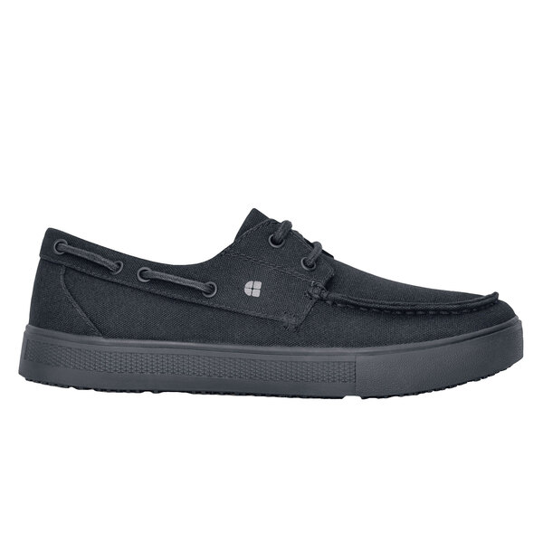 A black Shoes For Crews water-resistant casual shoe with laces and a rubber sole.
