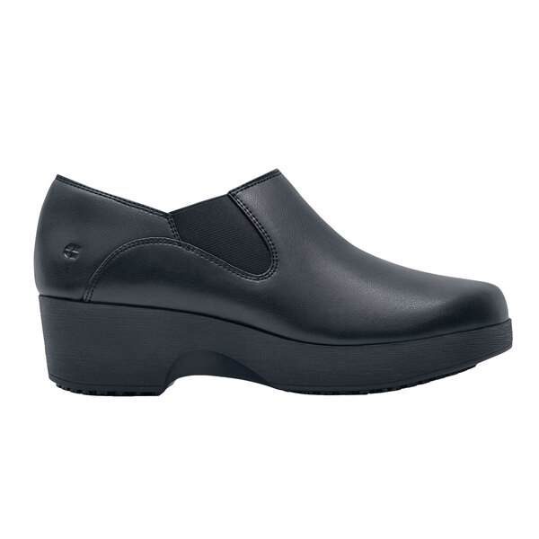A black leather Shoes For Crews women's casual shoe with a rubber sole.
