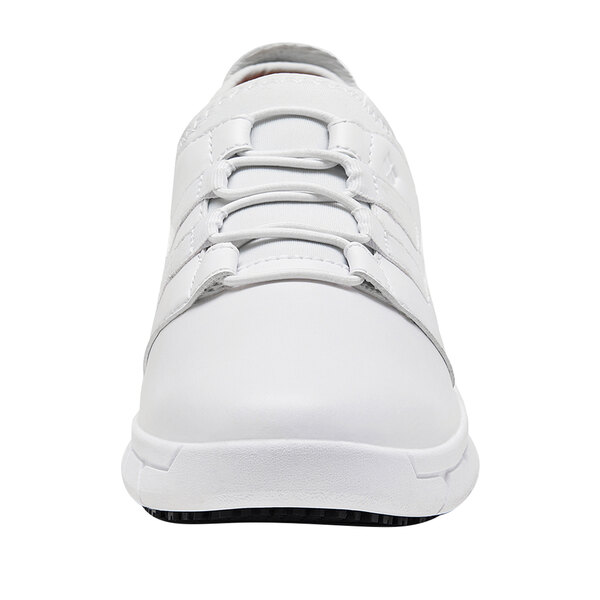 A white Shoes For Crews women's athletic shoe with laces.