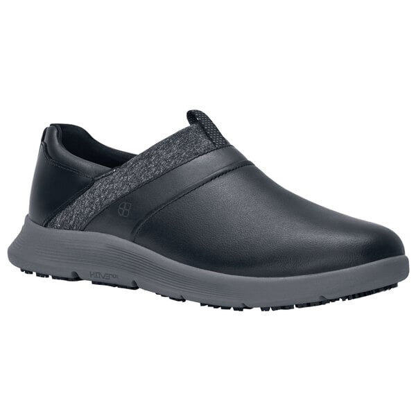 A black Shoes For Crews women's slip on shoe with grey accents.