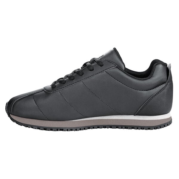 A black Shoes For Crews Avery women's athletic shoe with a white sole.