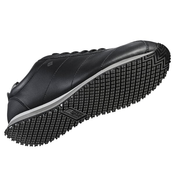 a black shoe with a white sole