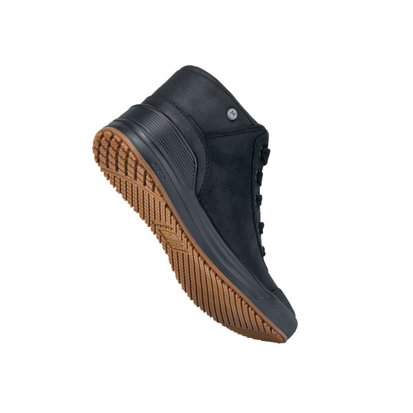 A close-up of a MOZO black shoe with a brown rubber sole.